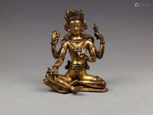 A YUAN DYNASTY BRONZE GILDED FOUR ARMS TARA STATUE