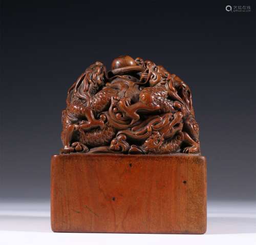 A QING DYNASTY SANDALWOOD NINE DRAGONS WITH A BEAD BUTTON SE...