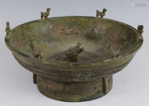 * A large Chinese cast bronze bowl, of Archaic form and rais...