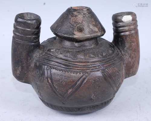 A blackware pouring vessel, having a cone shaped neck to a s...