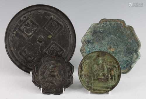 * A Chinese cast bronze hand mirror, of typical circular for...