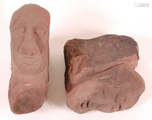 * A matched pair of sandstone corbels, each carved with an e...