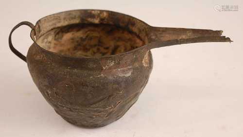 * A wrought copper alloy pouring vessel, embossed with hunte...