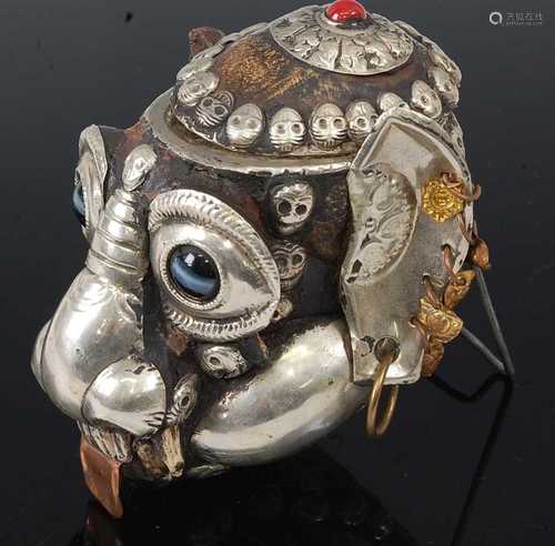 * A Tibetan white metal mounted monkey skull kapala cup, the...