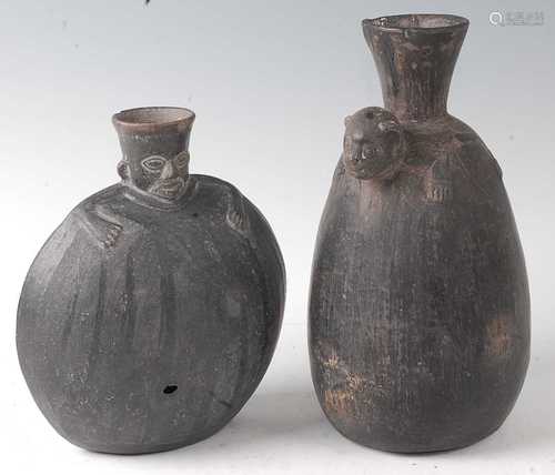 * A Huaco black-ware vessel of compressed circular form, the...