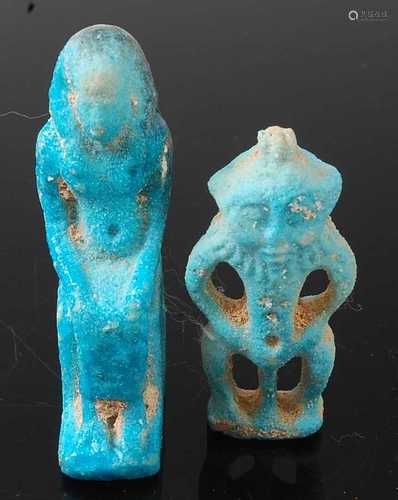 * A turquoise faience deity amulet, the seated figure in hea...