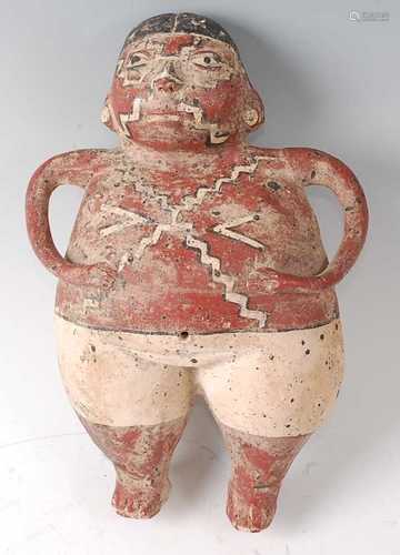 * A terracotta hollow form figure of a male in standing pose...