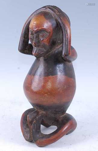 An unusual fertility figure, carved as a male figure in seat...