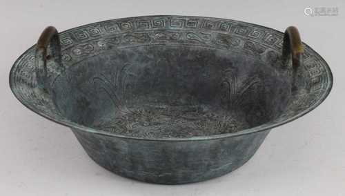 * A Chinese copper alloy twin handled basin, the interior re...