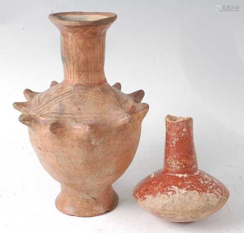 * A pottery vessel, having a flared rim to a bulbous body wi...