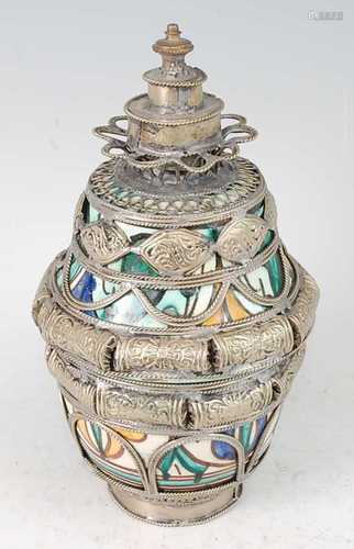 * A 20th century Tibetan ritual jar and cover, the earthenwa...