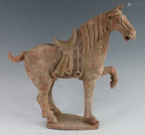 * A Chinese hollow moulded terracotta horse, modelled in sta...