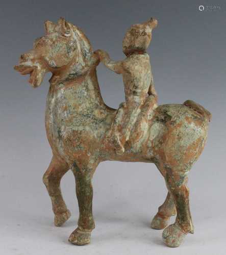 * A Chinese green glazed terracotta model of a horse and rid...