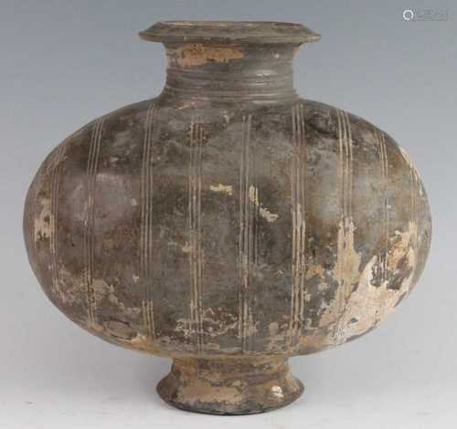 * A Chinese glazed pottery cocoon vase, the ovoid body incis...