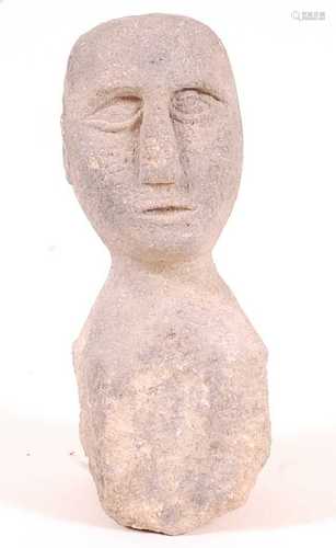 * A Celtic sandstone head, the bald head carved with a circu...