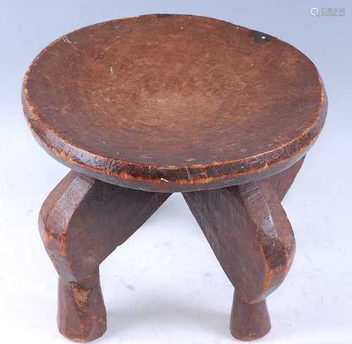 An East African Elders stool, having a plain dushed seat, ra...