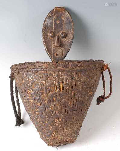 * A woven rattan reliquary basket, complete with a carved wo...