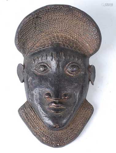 * A cast copper alloy currency mask, Bamun, Cameroon, mid 20...