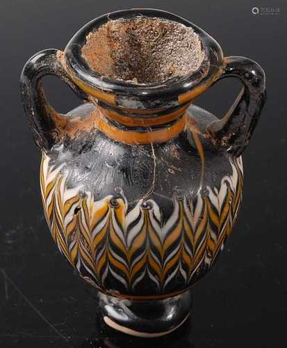 * An Amphora type pottery vase, having twin handles with fea...