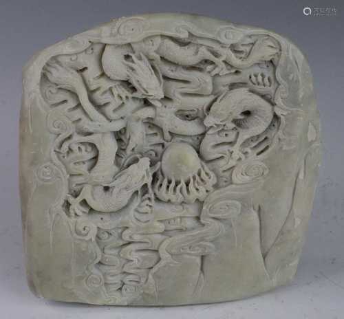 * A Chinese polished hardstone, carved in relief with dragon...