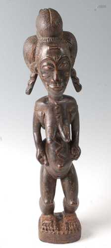 * A female ancestor figure, in standing pose with palm oil l...