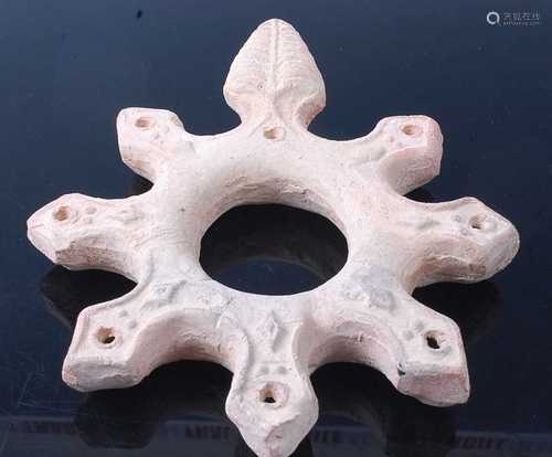 * A terracotta seven wick oil lamp base of star shape, repre...