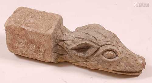 * A limestone gargoyle, carved as a dragons head, Medieval s...