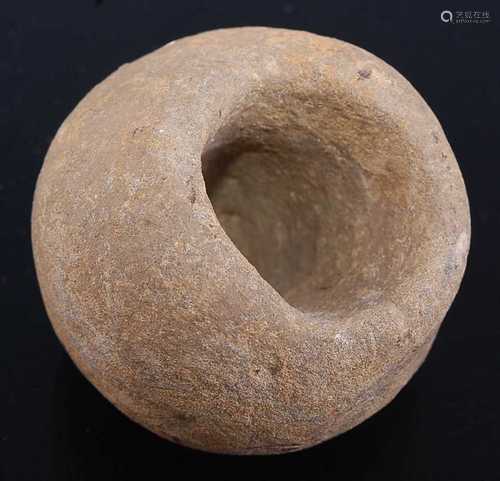 A stone mace head, of globular form with central aperture fo...