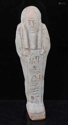 An Egyptian green glazed faience shabti, carved in typical s...