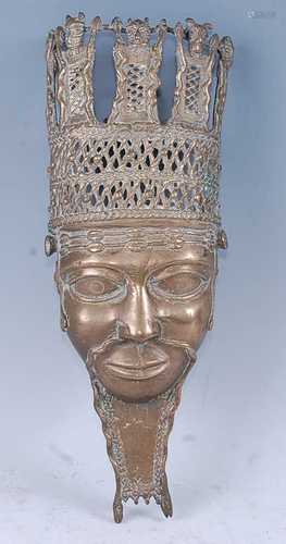 An African cast copper alloy wall mask, depicting the face o...