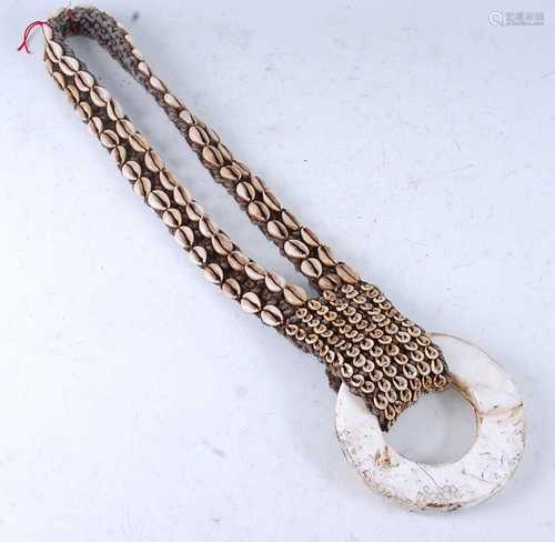 A West Papua necklace, the circular pendant on a woven and c...