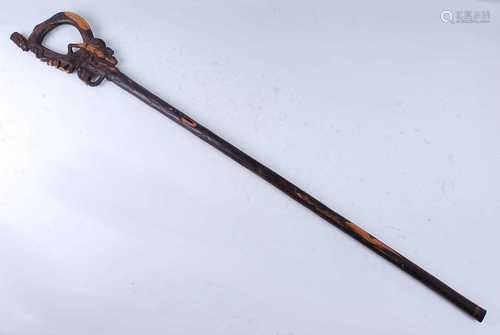 An unusual East African staff, the tip carved with a seated ...