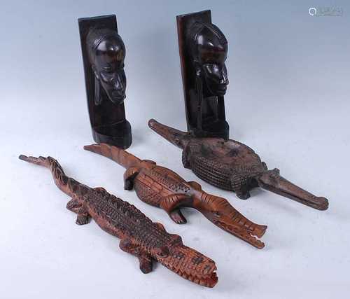 A collection of three native hardwood figures, each carved a...