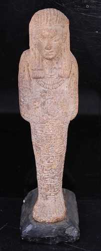 An Egyptian moulded and tooled shabti figure, in typical sta...