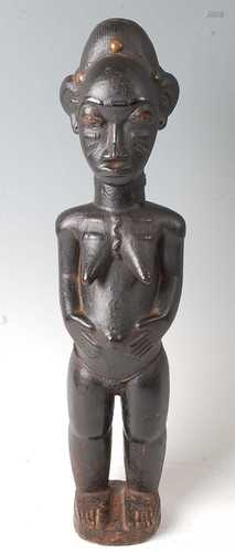 * A female ancestor figure, with libations of palm oil, meta...