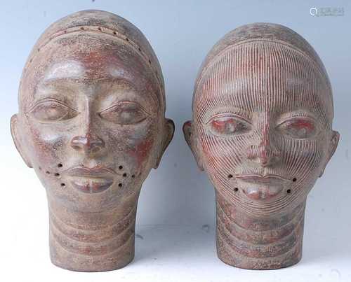 A near pair of terracotta heads, the first with a series of ...