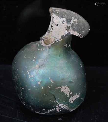 An Egyptian / Roman green glass scent bottle, having a flare...