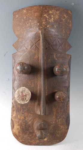 * A large carved wooden helmet mask, with remains of polychr...