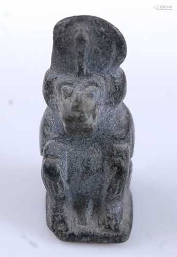 An Egyptian worked basalt amulet form bead, carved as the Ba...