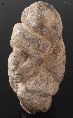 * A hardstone ritual figure, carved as a man in kneeling pos...