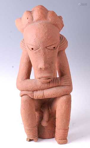 * A large terracotta figure of a seated male in the Nok styl...