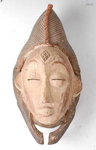 * A carved wooden initiation or spirit mask, having applied ...