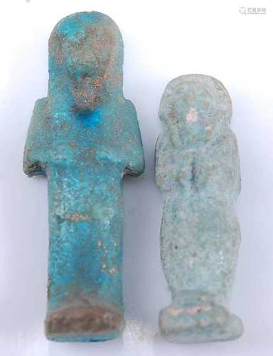 An Egyptian blue faience shabti figure, carved in typical st...