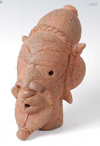 * A hand worked terracotta male head, Nok Culture, Nigeria, ...