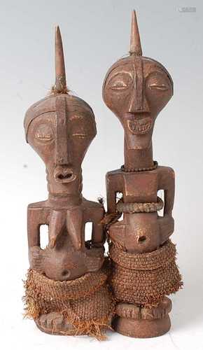 * A pair of wooden fetish figures, carved as a male and fema...