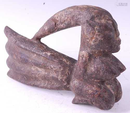 * A stone ritual figure, carved as a female in kneeling pose...