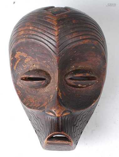 * A carved wooden dance / initiation mask, having lined deco...