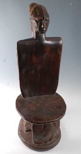 * A large carved hardwood figural chief's? chair, the top ca...