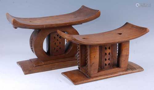 An Asante carved hardwood stool, the shaped seat on a compre...