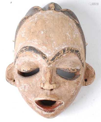 * A carved wooden ritual mask, with polychrome painted decor...